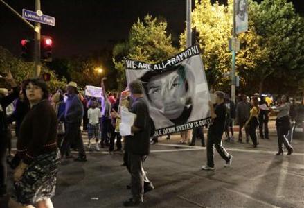 Protesters march in the Leimert Park area of Los Angeles following the George Zimmerman verdict